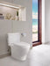 Modern bathroom with TOTO Nexus two-piece toilet and beach view window.