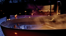 TOTO Flotation Tub With ZERO DIMENSION - Person relaxing in a hot tub with candles lit around at night