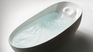 TOTO Flotation Tub With ZERO DIMENSION - Modern freestanding bathtub with water inside on a white background