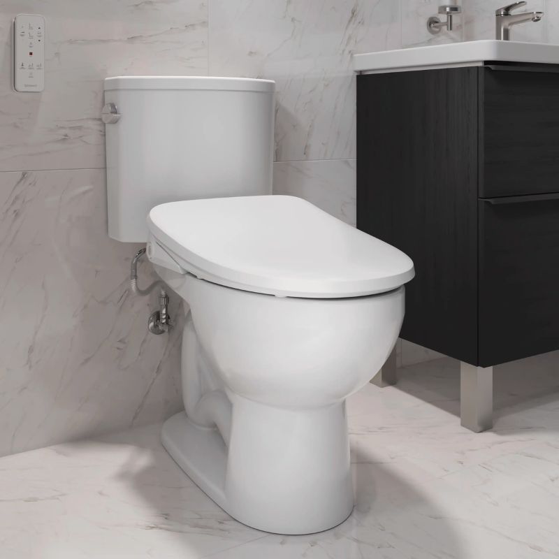 Duravit Sensowash Arcova Universal Bidet Seat - A white toilet with a closed lid shown in a modern bathroom setting with a dark wood vanity, marble-look tile walls, and a chrome faucet.