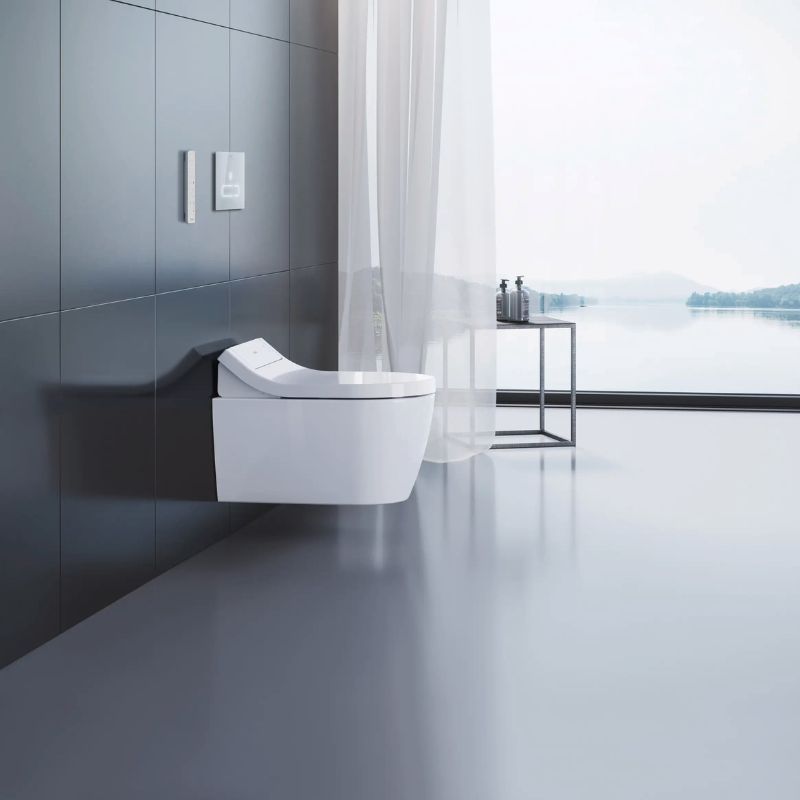 Duravit SensoWash Classic Durastyle Bidet Seat - Side view of wall hung modern toilet in a bathroom overlooking a lake