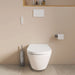 Duravit SensoWash D-Neo Bidet Seat - A modern wall-mounted white toilet with a matching lid, shown in a minimalist bathroom setting with a beige wall, a chrome toilet brush holder, and a white flush plate.