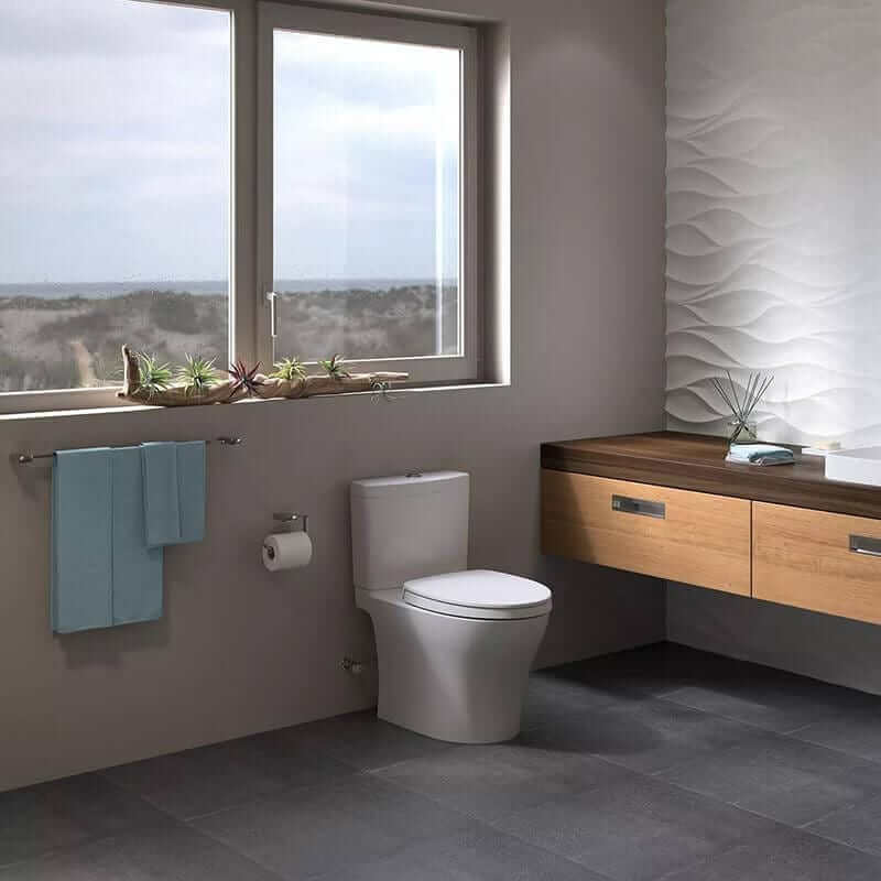 TOTO Aquia IV Two-Piece Toilet - Universal Height - Modern bathroom with a toilet, wooden vanity, and large window.