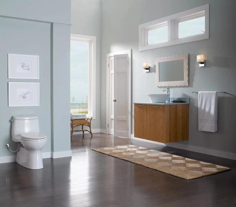 Modern bathroom featuring TOTO Carlyle II One-Piece Toilet with chrome trip lever and skirted design, emphasizing elegance and efficiency.