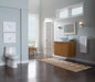 Elegant bathroom interior featuring TOTO Carlyle II One-Piece Toilet - 1.28 GPF beside a modern wooden vanity and large window view.