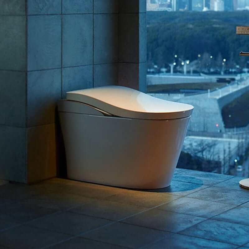 TOTO Neorest LS Bidet Toilet - Modern toilet in a bathroom with a view of a cityscape at night.