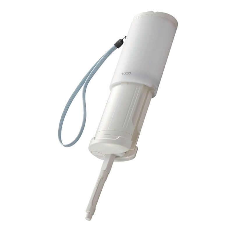TOTO Travel Washlet - White handheld bidet washlet with a strap on a white background