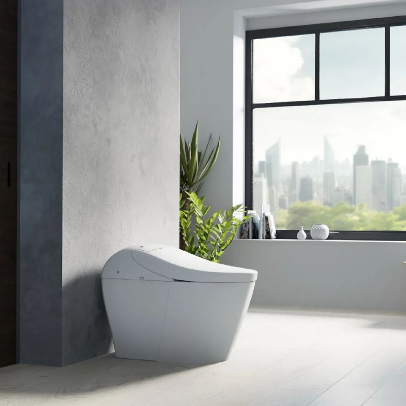 TOTO Washlet G5A Lite Integrated Smart Toilet - Modern white freestanding bathtub in a bathroom with a cityscape view
