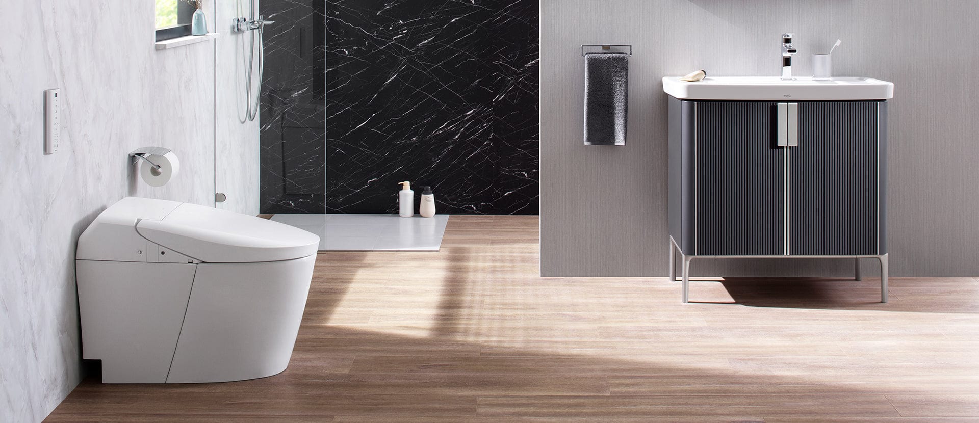 Modern bathroom featuring TOTO Washlet G5A Smart Bidet Toilet with marble shower and sleek vanity unit.