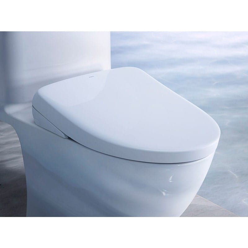 TOTO Washlet S7A Bidet Seat installed on a modern toilet in a bathroom setting, showcasing sleek design and functionality.